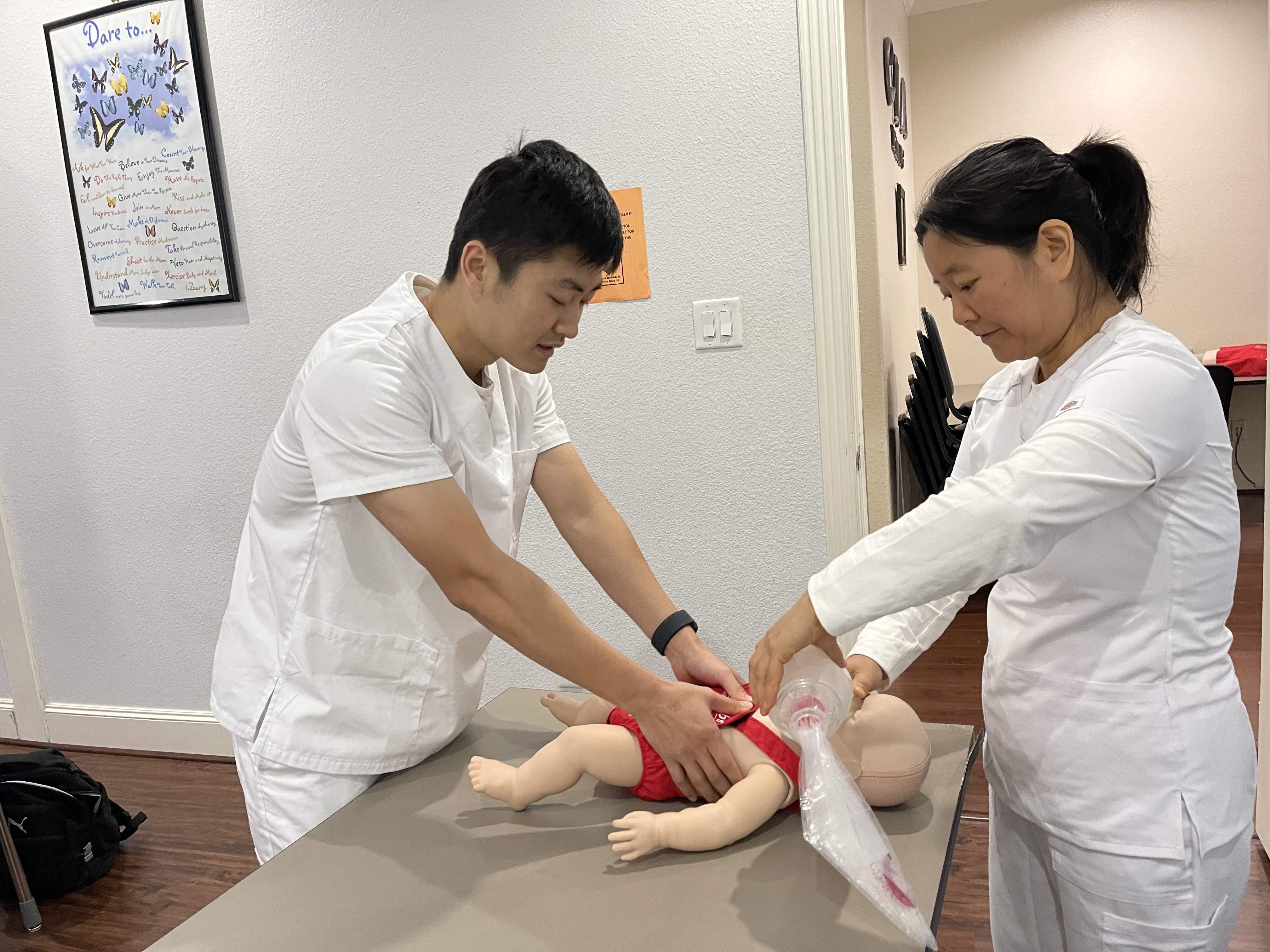 Certified Nursing Assistant practicing CPR techniques during hands-on training